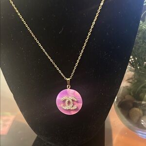 Gold-Tone Necklace with Pink Iridescent Pendant and Crystal Logo Accent